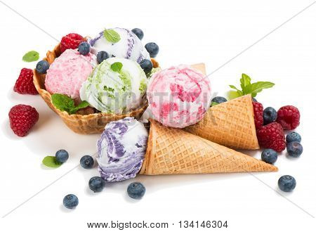 Three different flavor ice creams with cones and basket fresh berries of raspberry and blueberry isolated on a white background.