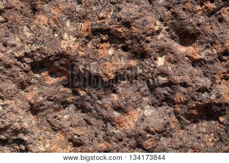 Surface of a porphyry rhyolite rock from central Europe Saxony-Anhalt. The rock contains fragments of feldspars quartz and amphibole minerals in a fine grained matrix.