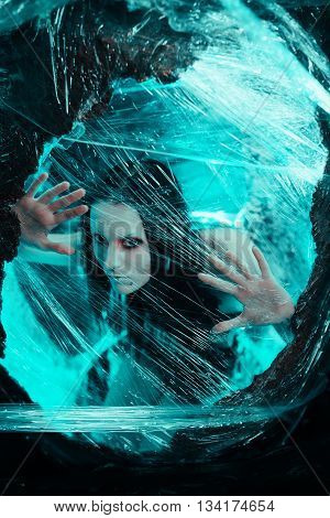 Woman sitting in big cocoon. Creative photoshoot