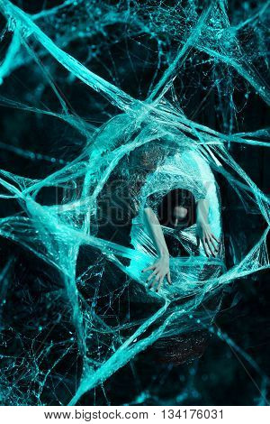 Woman sitting in big cocoon. Creative photoshoot