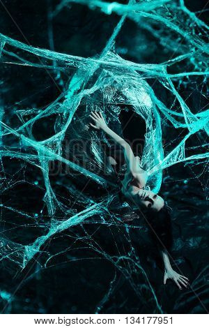 Girl like a spider getting out from the cocoon