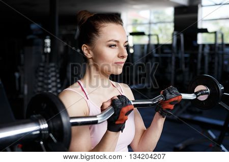 Young Beautiful Woman Training Biceps With Barbell