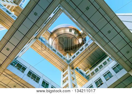 TOKYO JAPAN - NOVEMBER 27 2015: Fuji T.V. headquarters one of the most striking buildings in Japan. its' futuristic metallic clad building featuring a massive silver ball 32 metres in diameter