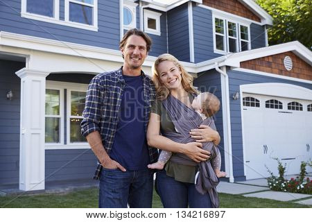 Portrait Of Family Standing Outside House