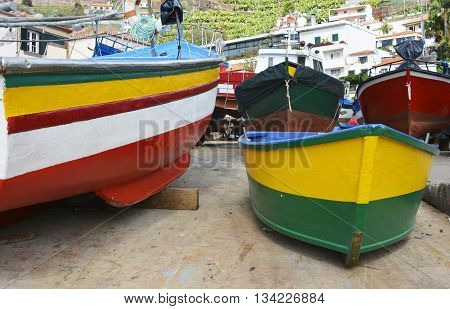 Newly painted red yellow and green fishing boats at Camara de Lobos in Madeira Portugal
