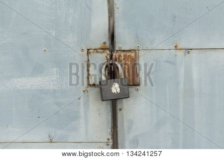 Old iron lock on the metal door