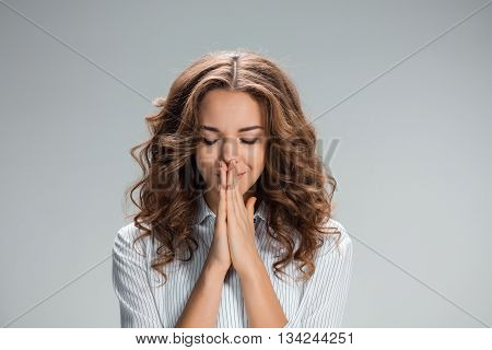 The Woman is looking imploring over gray background
