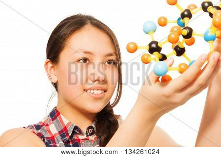 Beautiful young Asian student assembling molecule models, isolated on white background