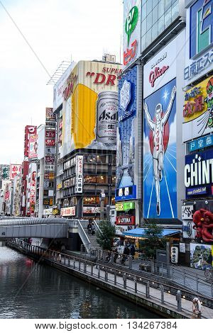 OSAKA JAPAN - NOVEMBER 20 2015 : The Glico Man light billboard and other brand logos in Dotonbori street Namba District one of famous tourist spots in Osaka Japan.