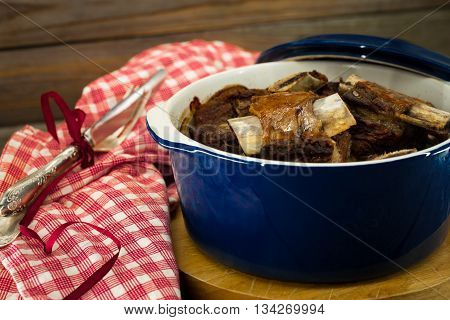 stew in a blue pot on the wooden background tasty meat