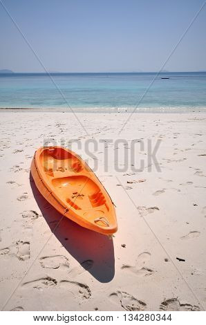 Old Orange boat on white beach on warm sunset, Selective focus of boat