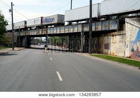 JOLIET, ILLINOIS / UNITED STATES - MAY 3, 2015: A freight train crosses a bridge over Scott Street near downtown Joliet, Illinois.