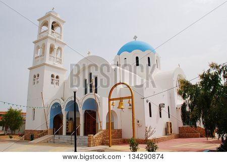 AGISTRI, GREECE - MAY 12, 2016: The domed church of Agioi Anargyroi at Skala on the Greek island of Agistri. The small island is under an hour from Piraeus harbour in Athens.