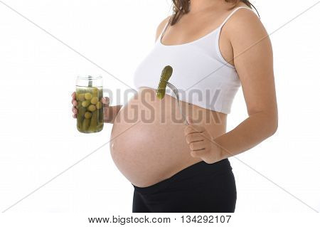 young pregnant woman showing big belly holding olives jar and fork with pickle isolated on white background in pregnancy whim food concept isolated on white background