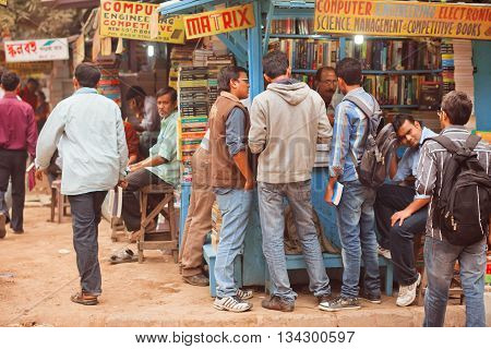 KOLKATA, INDIA - JAN 15, 2016: Students looking for the different books at outdoor book market on January 15, 2016 in Kolkata. From 1976 Kolkata have the Book Fair with 2 million visitors annual.