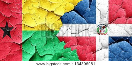 Guinea bissau flag with Dominican Republic flag on a grunge crac