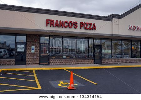 JOLIET, ILLINOIS / UNITED STATES - OCTOBER 9, 2015: One may eat pizza at Franco's Pizza restaurant, in the Crossroads Plaza.