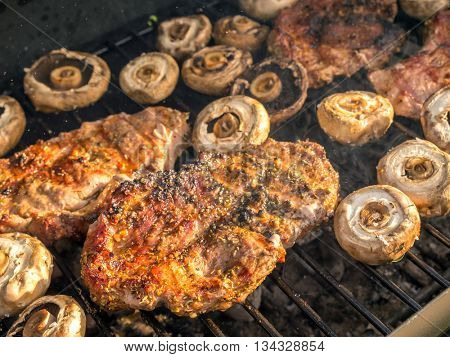 Pork butt chops being grilled on barbecue
