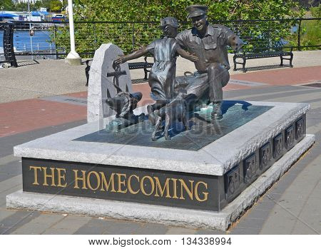 VICTORIA BC CANADA JUNE 24 2015: 'The Homecoming' by Nathan Scott, which is a bronze figure sculpture commemorating the 100th Anniversary for the Canadian Navy and displayed downtown Victoria BC