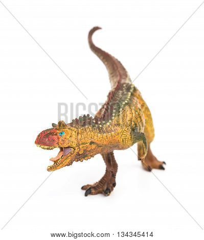 brown carnotaurus toy on a white background
