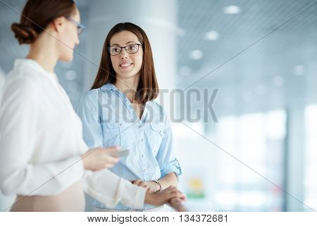 Two female colleagues communicating with each other