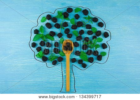 draw a tree of blackberries on a blue wooden background