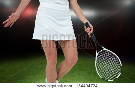 Athlete playing tennis with a racket against american football arena