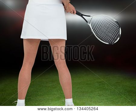 Athlete playing tennis with a racket against american football arena