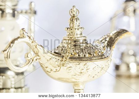 Aladdin's magic lamp with out of focus light as background