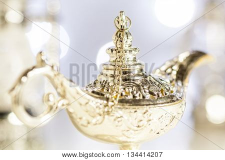 Aladdin's magic lamp with out of focus light as background
