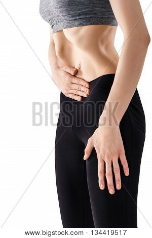 Sporty beautiful young woman practicing Uddiyana Bandha technique isolated on white