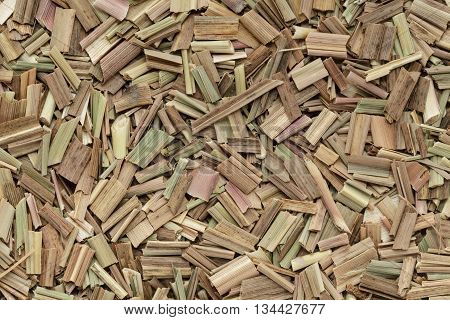 Organic dry lemongrass (Cymbopogon flexuosus) big cut. Macro close up background texture. Top view.