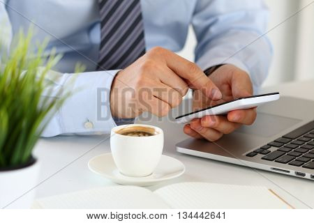 Close up view of businessman hands holding smart phone. Mobile applications playing games social media organizing work online banking or purchase concept.