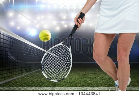 Athlete playing tennis with a racket against american football arena