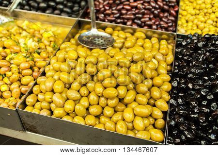 Pickled olives in the Mahane Yehuda Market in Jerusalem. Selling and buying.