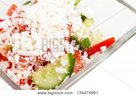 Traditional bulgarian salad shopski with fresh vegetables and grated sheep cheese. Macro. Photo can be used as a whole background.
