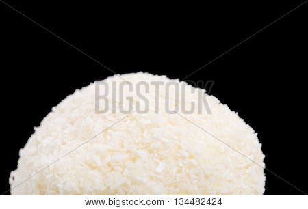 Delicious almond and coconut candy. Macro. Against black background.