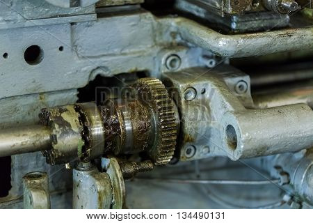 The old mechanism that the gear and the Cam clutch to turn off the rotation. Covered with thick grease. Part of industrial machine.