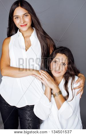 cute pretty teen daughter with mature mothr hugging, fashion style brunette 