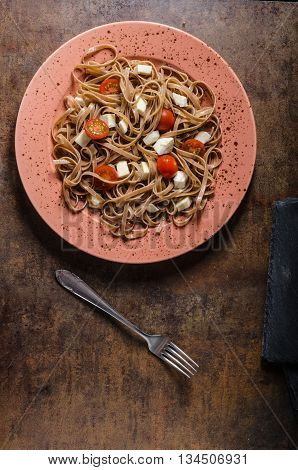 Spaghetti With Mozzarella, Cherry Tomatoes And Arugula