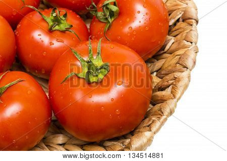 fresh tomatoes in a basket on a white backgroundtomatoes in the basket