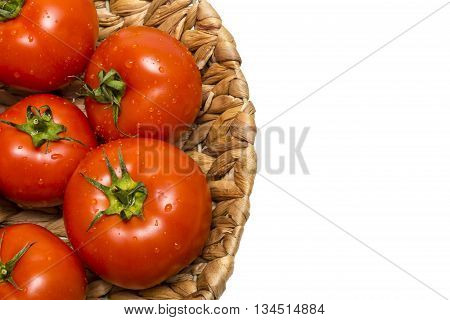 fresh tomatoes in a basket on a white backgroundtomatoes in the basket