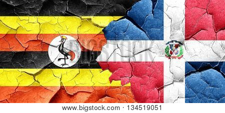 Uganda flag with Dominican Republic flag on a grunge cracked wal