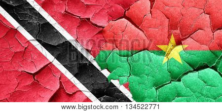 Trinidad and tobago flag with Burkina Faso flag on a grunge crac