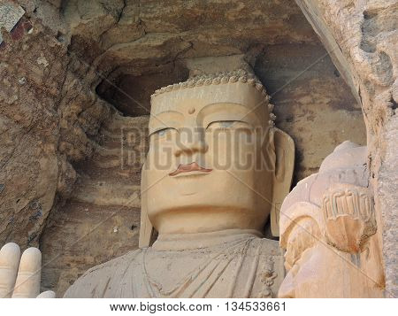 The 28 m Giant Buddha (Dafo) of buddhist cave complex aaa(Tiantishan Grottoes) is located approximately 55 km south-east of Wuwei (Gansu, China) on the rocky eastern shore of the Huangyang reservoir, 12 m below the water level.