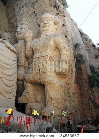 The 28 m Giant Buddha (Dafo) of buddhist cave complex Tiantishan (Tiantishan Grottoes) is located approximately 55 km south-east of Wuwei (Gansu, China) on the rocky eastern shore of the Huangyang reservoir, 12 m below the water level.