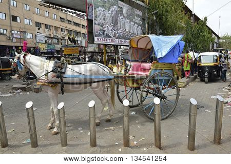 Bombay, India - June 10, 2016: Horse Cart and Auto rickshaw outside Central Railways Kalyan Junction, Bombay, Maharashtra