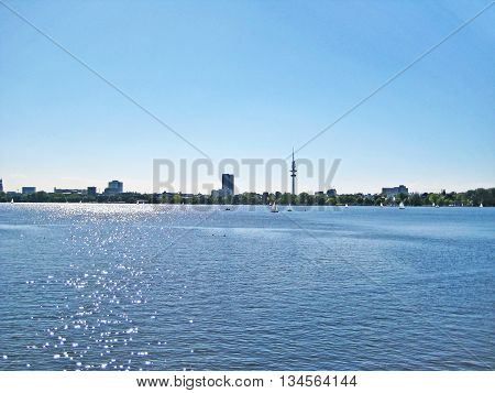 Hamburg lake Aussenalster with sailing boats - skyline of Hamburg city