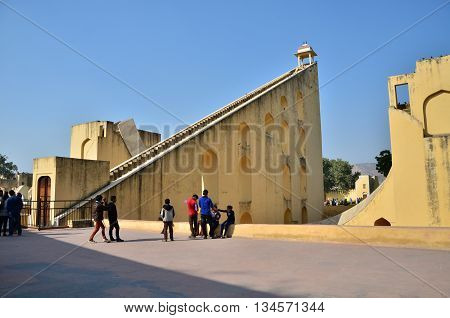 Jaipur India - December 29 2014: Tourist visit Jantar Mantar observatory on December 29 2014 in Jaipur India. The collection of architectural astronomical instruments were built by Sawai Jai Singh II in 1727-1734.
