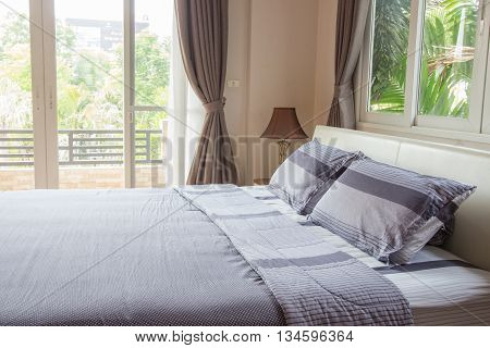 Close up of big comfortable double bed in modern bedroom